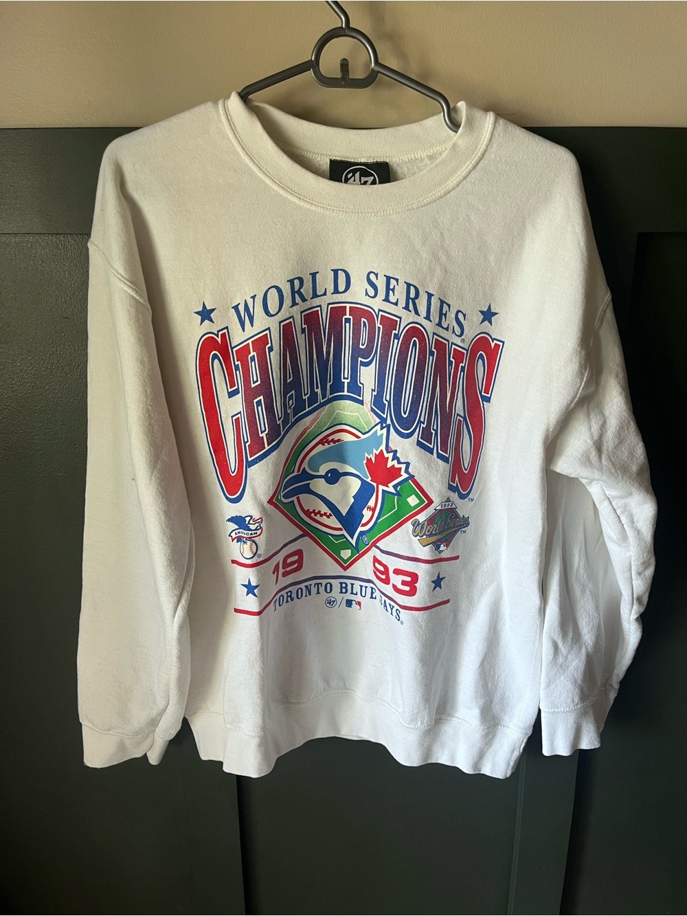 47 Men's Toronto Blue Jays White Crewneck Sweatshirt with Red & Blue Graphics